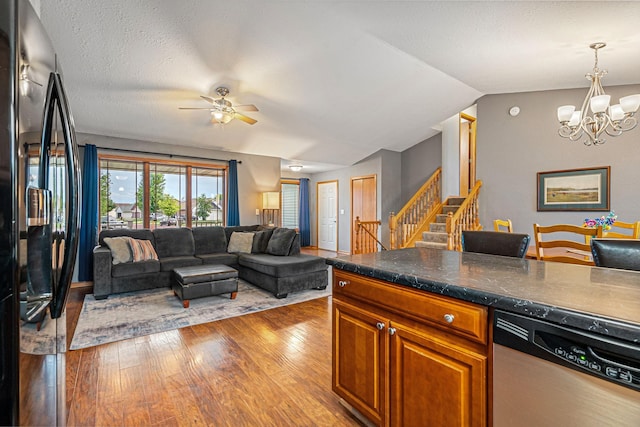 133 Uriah Ct, Mankato, MN 56001 - kitchen featuring stainless steel dishwasher, black fridge, wood finished floors, a ceiling fan, and a chandelier