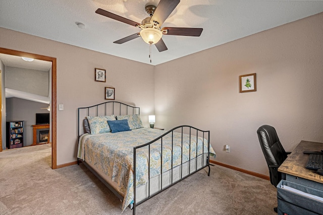 133 Uriah Ct, Mankato, MN 56001 - carpeted bedroom with an office area, a ceiling fan, and a warm lit fireplace