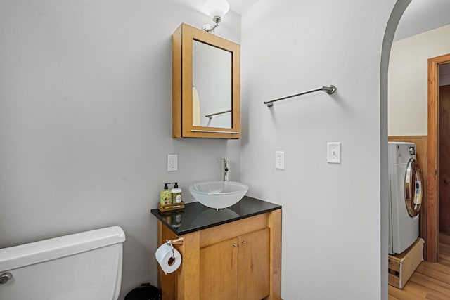 133 Uriah Ct, Mankato, MN 56001 - half bathroom featuring washer / clothes dryer, vanity, and wood finished floors