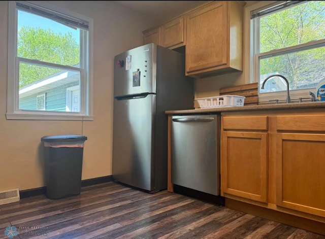 319 13th St N, Moorhead, MN 56560 - kitchen with stainless steel appliances, dark wood-style floors, and brown cabinetry