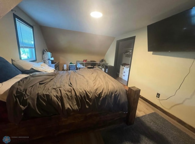 319 13th St N, Moorhead, MN 56560 - bedroom featuring wood finished floors, vaulted ceiling, and recessed lighting