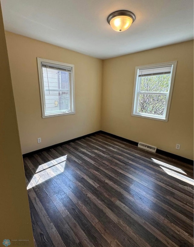 319 13th St N, Moorhead, MN 56560 - spare room with healthy amount of natural light and dark wood-style flooring