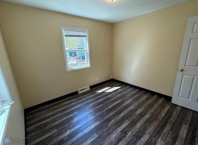 319 13th St N, Moorhead, MN 56560 - unfurnished room with dark wood-type flooring and baseboards