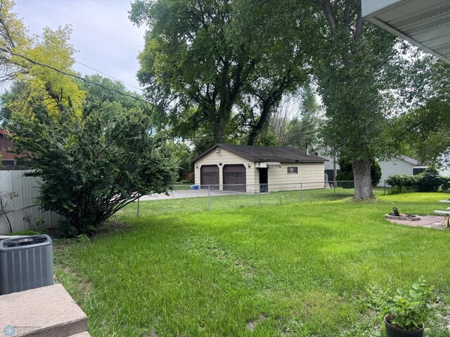 319 13th St N, Moorhead, MN 56560 - view of yard with a garage and an outdoor structure