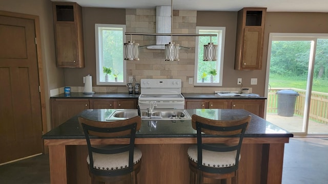 4247 Crow Wing Cir SW, Sylvan Twp, MN 56473 - kitchen featuring electric stove, dark countertops, and brown cabinetry