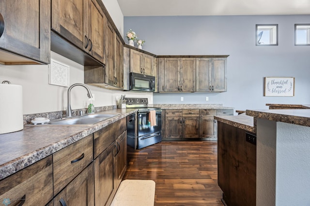 5543 Tuscan Ct S, Fargo, ND 58104 - kitchen with dark wood-type flooring, black appliances, and dark countertops