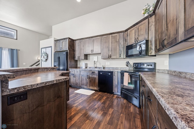 5543 Tuscan Ct S, Fargo, ND 58104 - kitchen with black appliances, dark countertops, dark wood-style floors, and dark brown cabinets