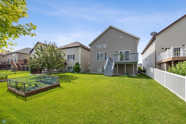 5543 Tuscan Ct S, Fargo, ND 58104 - back of house with stairway, a garden, a deck, and a fenced backyard