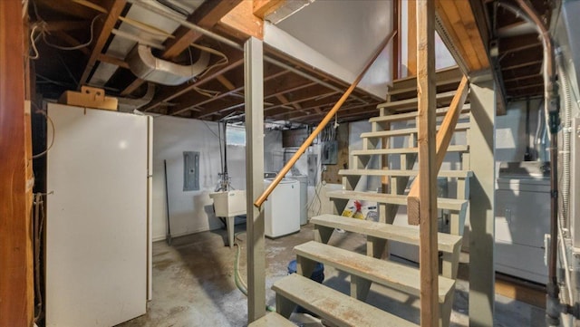 806 8th St SW, Willmar, MN 56201 - unfinished below grade area with washing machine and dryer, electric panel, stairway, and freestanding refrigerator