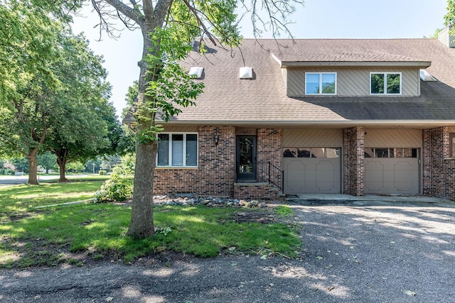 1607 Pleasant View Dr, North Mankato, MN 56003 - view of front of home featuring brick siding, driveway, a garage, and roof with shingles