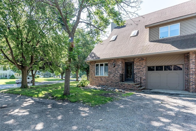 1607 Pleasant View Dr, North Mankato, MN 56003 - view of front of home featuring brick siding, a chimney, a shingled roof, and gravel driveway