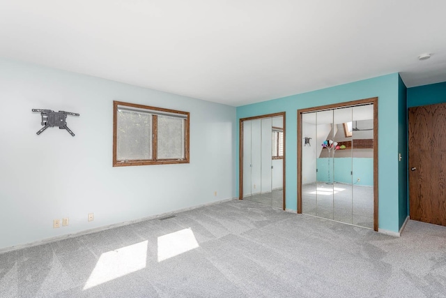 1607 Pleasant View Dr, North Mankato, MN 56003 - unfurnished bedroom featuring multiple closets and carpet floors