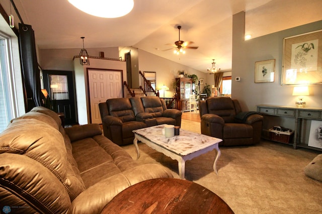 1307 Libra Ln, Fargo, ND 58104 - living room featuring a chandelier, lofted ceiling, a ceiling fan, carpet flooring, and stairs