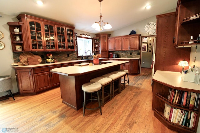 1307 Libra Ln, Fargo, ND 58104 - kitchen with open shelves, light countertops, tasteful backsplash, a center island, and a kitchen breakfast bar