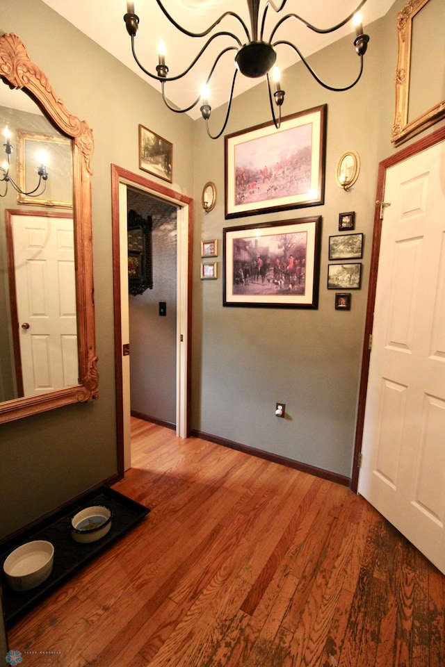 1307 Libra Ln, Fargo, ND 58104 - hallway with a chandelier and wood finished floors