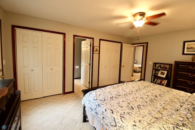 1307 Libra Ln, Fargo, ND 58104 - bedroom featuring multiple closets, light colored carpet, and ceiling fan