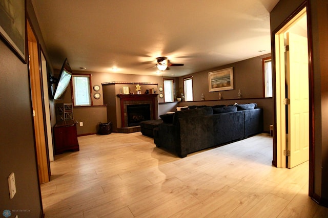 1307 Libra Ln, Fargo, ND 58104 - living room with ceiling fan, a fireplace with raised hearth, and light wood finished floors