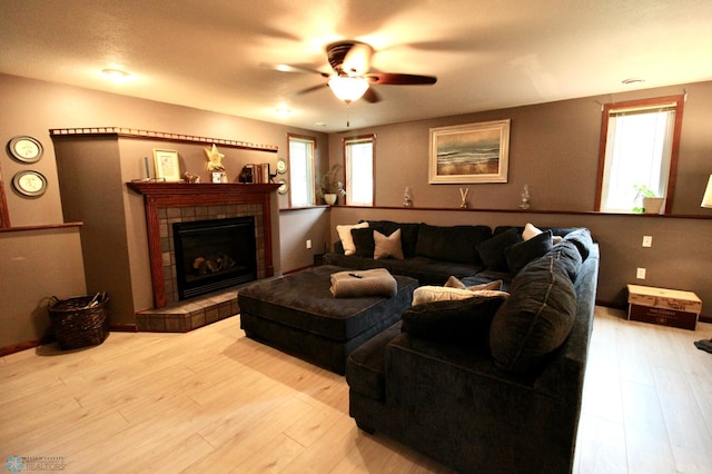 1307 Libra Ln, Fargo, ND 58104 - living area with healthy amount of natural light, wood finished floors, ceiling fan, and a tile fireplace