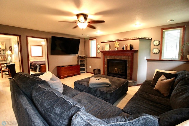 1307 Libra Ln, Fargo, ND 58104 - living room with ceiling fan, light wood-style flooring, and a tile fireplace