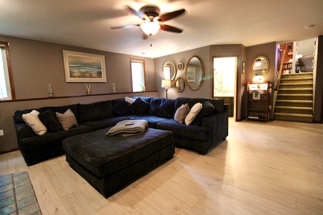 1307 Libra Ln, Fargo, ND 58104 - living room with a ceiling fan, stairway, and light wood-style floors