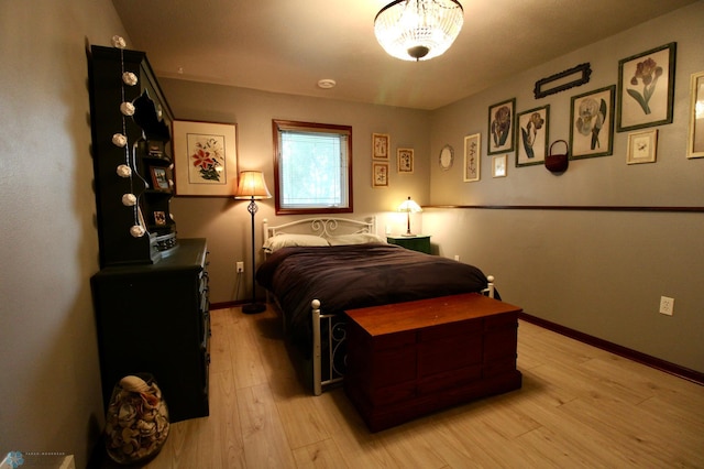 1307 Libra Ln, Fargo, ND 58104 - bedroom featuring light wood finished floors and a chandelier