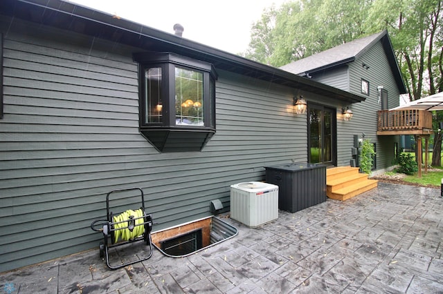 1307 Libra Ln, Fargo, ND 58104 - view of side of home with a cooling unit and a patio