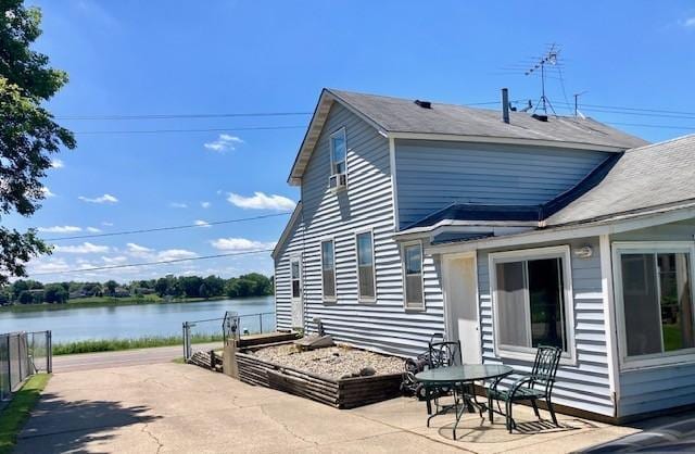 208 Benton St W, Cologne, MN 55322 - view of side of home featuring a patio and a water view