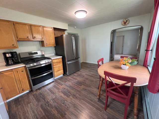 208 Benton St W, Cologne, MN 55322 - kitchen featuring appliances with stainless steel finishes, dark wood finished floors, light countertops, arched walkways, and brown cabinets