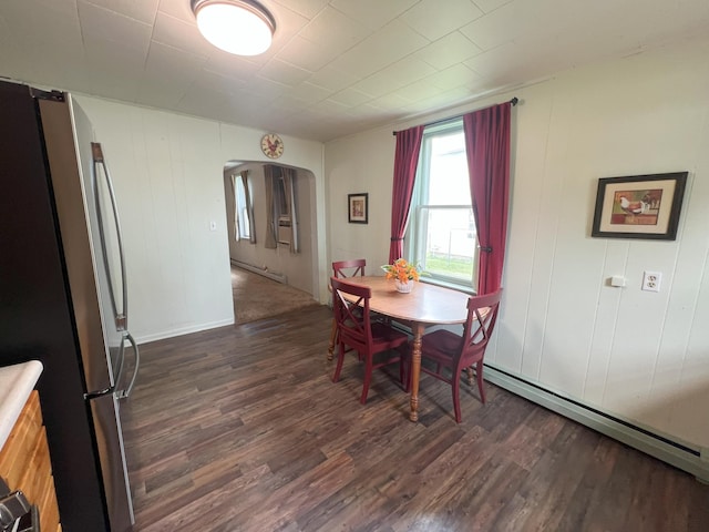 208 Benton St W, Cologne, MN 55322 - dining area featuring dark wood-type flooring, a baseboard radiator, a baseboard heating unit, and arched walkways