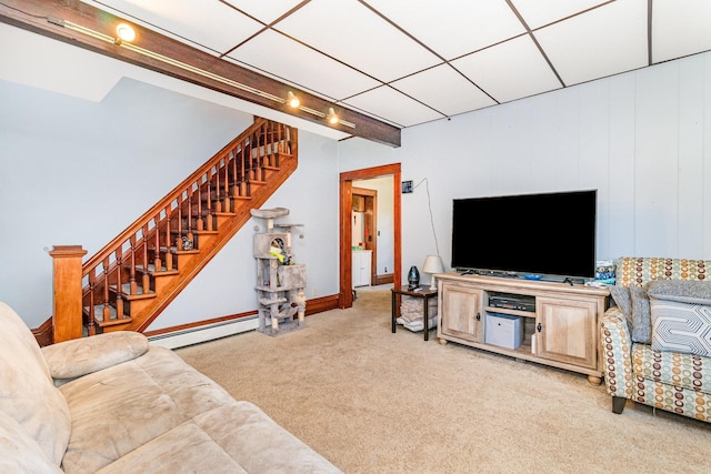 41793 Kilkenny Rd, Kilkenny, MN 56052 - carpeted living room featuring baseboard heating, stairs, and track lighting