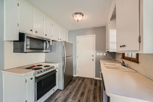 457 108th Ln NW, Coon Rapids, MN 55448 - kitchen featuring stainless steel appliances, dark wood-style flooring, light countertops, and white cabinetry