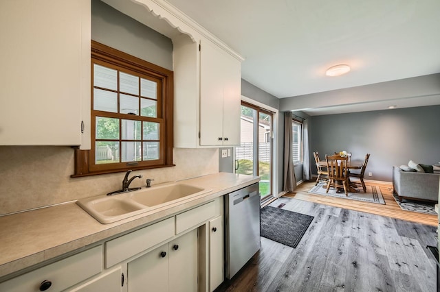 457 108th Ln NW, Coon Rapids, MN 55448 - kitchen featuring wood finished floors, stainless steel dishwasher, light countertops, and white cabinetry