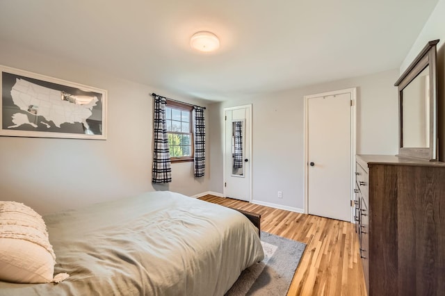 457 108th Ln NW, Coon Rapids, MN 55448 - bedroom featuring light wood-style flooring and baseboards
