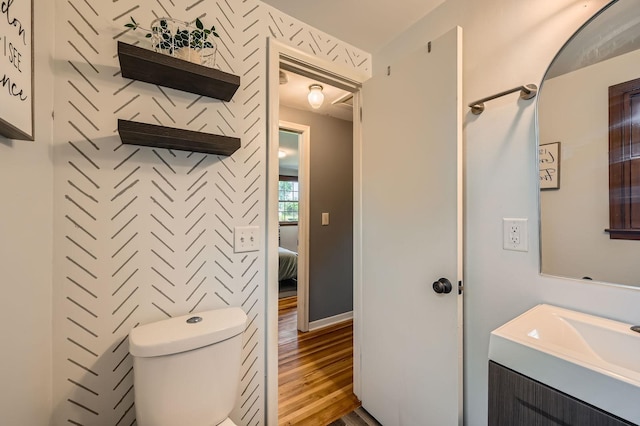 457 108th Ln NW, Coon Rapids, MN 55448 - half bathroom with wood finished floors and vanity