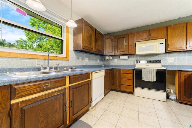 4043 Rehbein Rd, Duluth, MN 55803 - kitchen with white appliances, tasteful backsplash, light tile patterned floors, and decorative light fixtures
