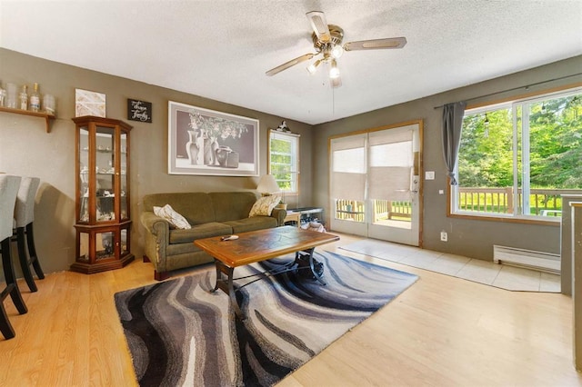 4043 Rehbein Rd, Duluth, MN 55803 - living room featuring a baseboard radiator, a ceiling fan, wood finished floors, and a textured ceiling