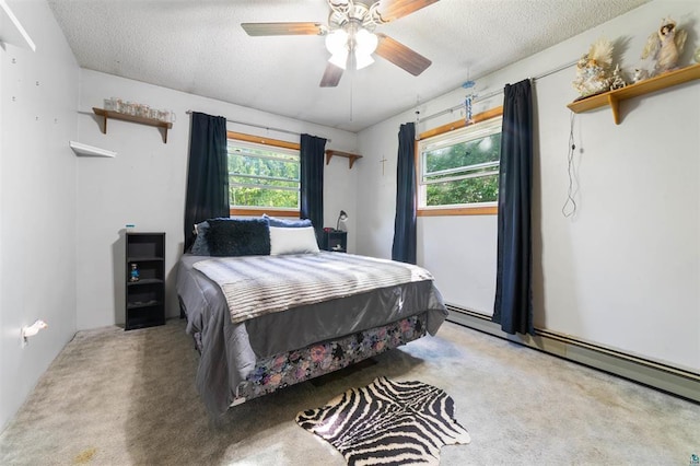 4043 Rehbein Rd, Duluth, MN 55803 - bedroom with a baseboard heating unit, a textured ceiling, carpet, and ceiling fan