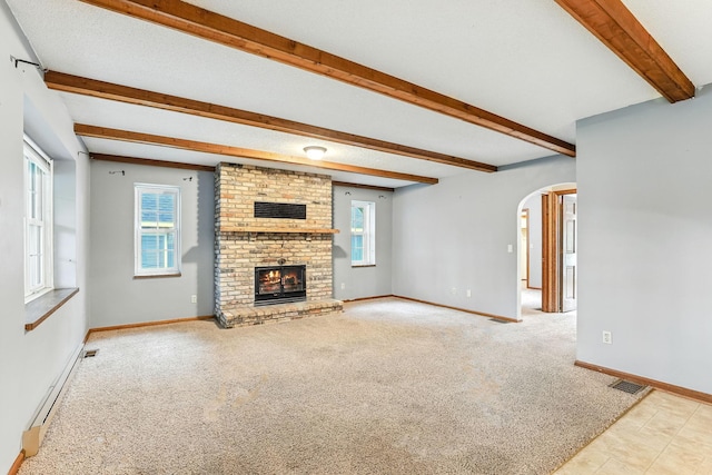 453 Van Dyke St, Saint Paul, MN 55119 - unfurnished living room with arched walkways, beam ceiling, a fireplace, a baseboard heating unit, and carpet flooring