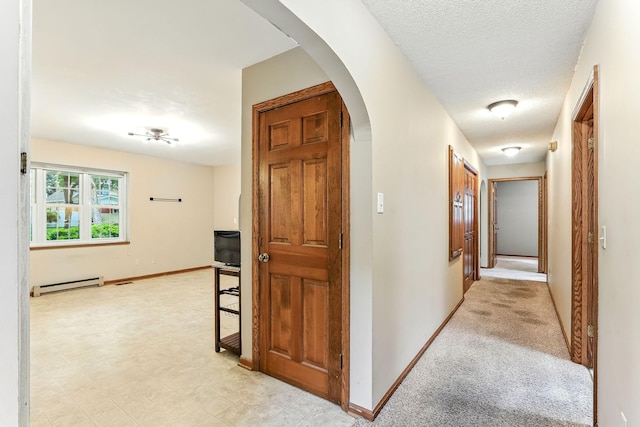 453 Van Dyke St, Saint Paul, MN 55119 - hallway featuring a baseboard heating unit, arched walkways, and a textured ceiling