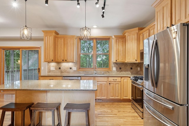 4116 River Run, Savage, MN 55378 - kitchen with appliances with stainless steel finishes, light brown cabinetry, and plenty of natural light