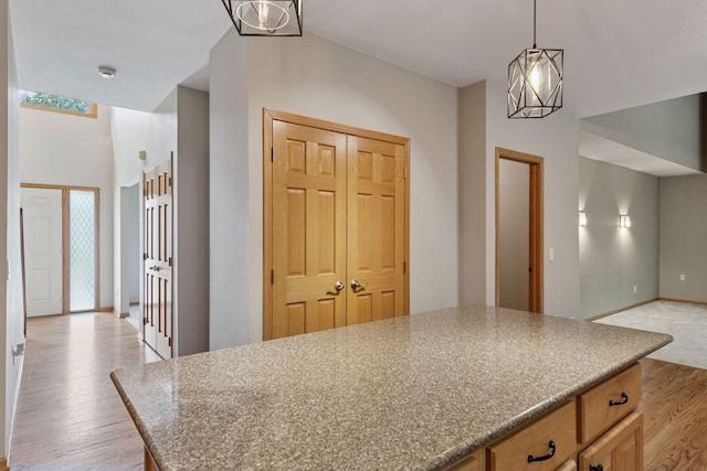 4116 River Run, Savage, MN 55378 - kitchen featuring light wood finished floors, a chandelier, pendant lighting, and a kitchen island
