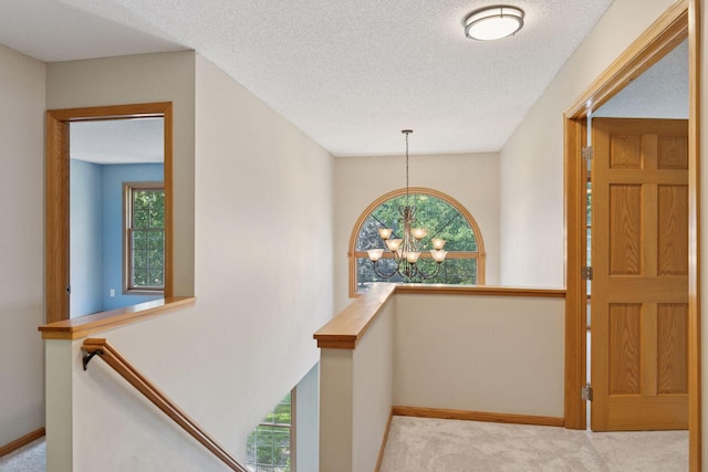 4116 River Run, Savage, MN 55378 - hall with an upstairs landing, carpet, a chandelier, and a textured ceiling