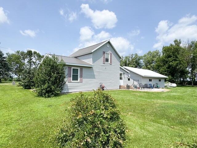 35448 200th St, Brewster, MN 56119 - view of property exterior with a patio, a lawn, and a metal roof