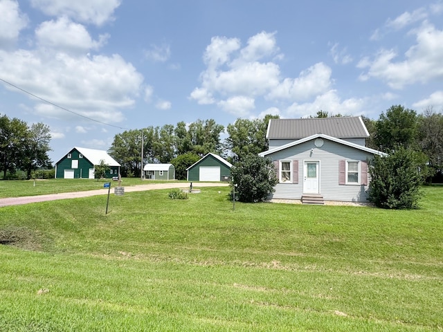 35448 200th St, Brewster, MN 56119 - view of grassy yard with driveway, a detached garage, and entry steps