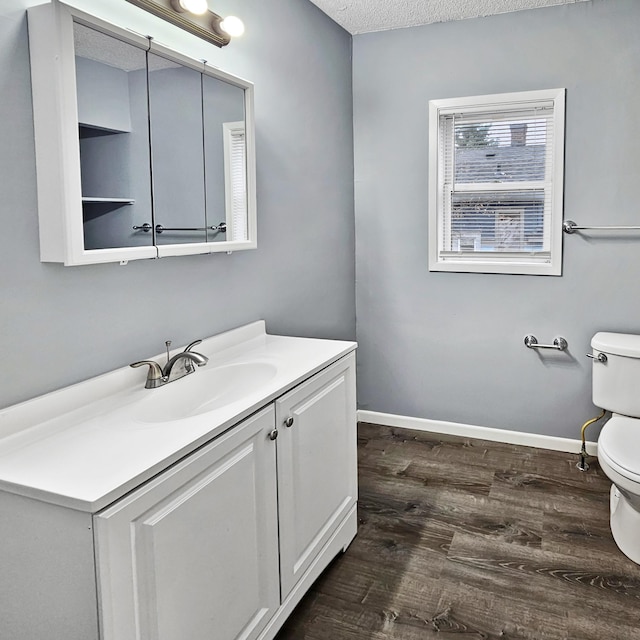 3253 Humboldt Ave N, Minneapolis, MN 55412 - half bathroom with vanity, wood finished floors, and a textured ceiling