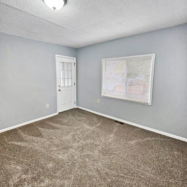 3253 Humboldt Ave N, Minneapolis, MN 55412 - empty room featuring carpet floors and a textured ceiling