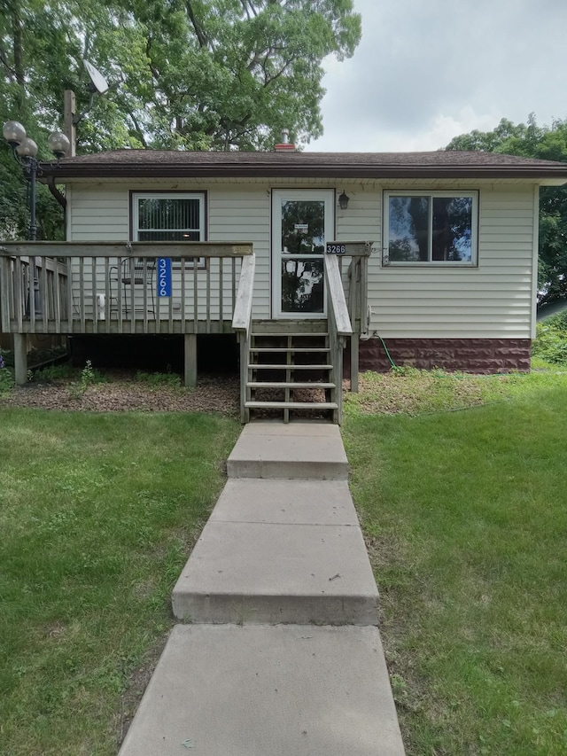 3266 Owasso Blvd, Shoreview, MN 55126 - view of front of house with a front yard, a deck, and a shingled roof