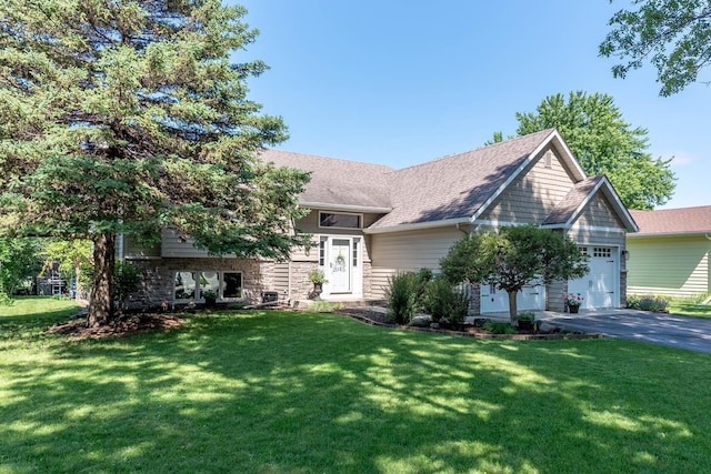 2045 Roberta Dr, North Mankato, MN 56003 - view of front of property featuring a garage, a front yard, driveway, and a shingled roof