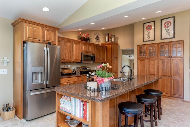 2045 Roberta Dr, North Mankato, MN 56003 - kitchen with stainless steel appliances, lofted ceiling, brown cabinetry, a kitchen breakfast bar, and recessed lighting