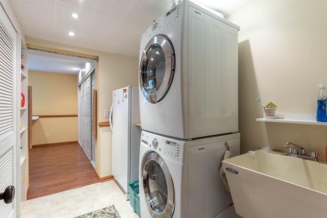2045 Roberta Dr, North Mankato, MN 56003 - laundry area with stacked washer and clothes dryer and recessed lighting